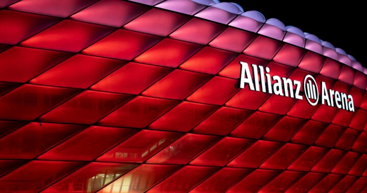 a large red building with a sign that says allianz arena